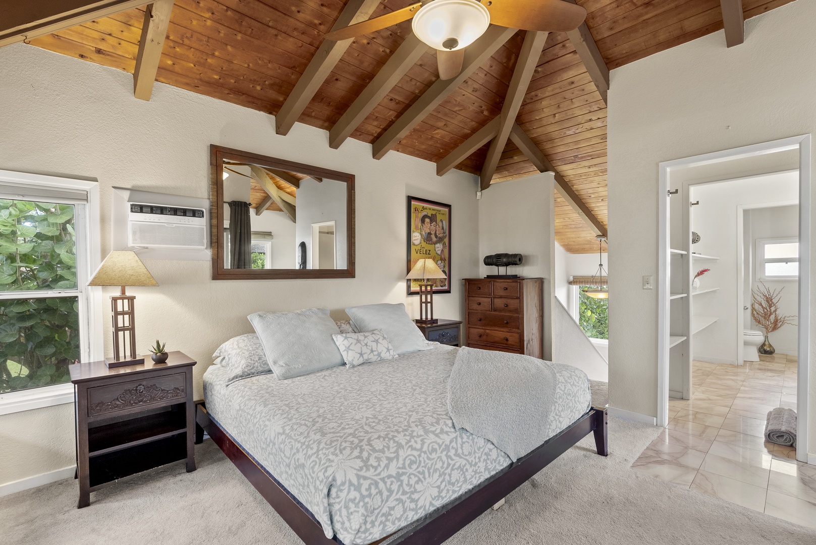 Haleiwa Vacation Rentals, North Shore Beachfront Resort - Spacious primary bedroom with a king-size bed and serene decor.