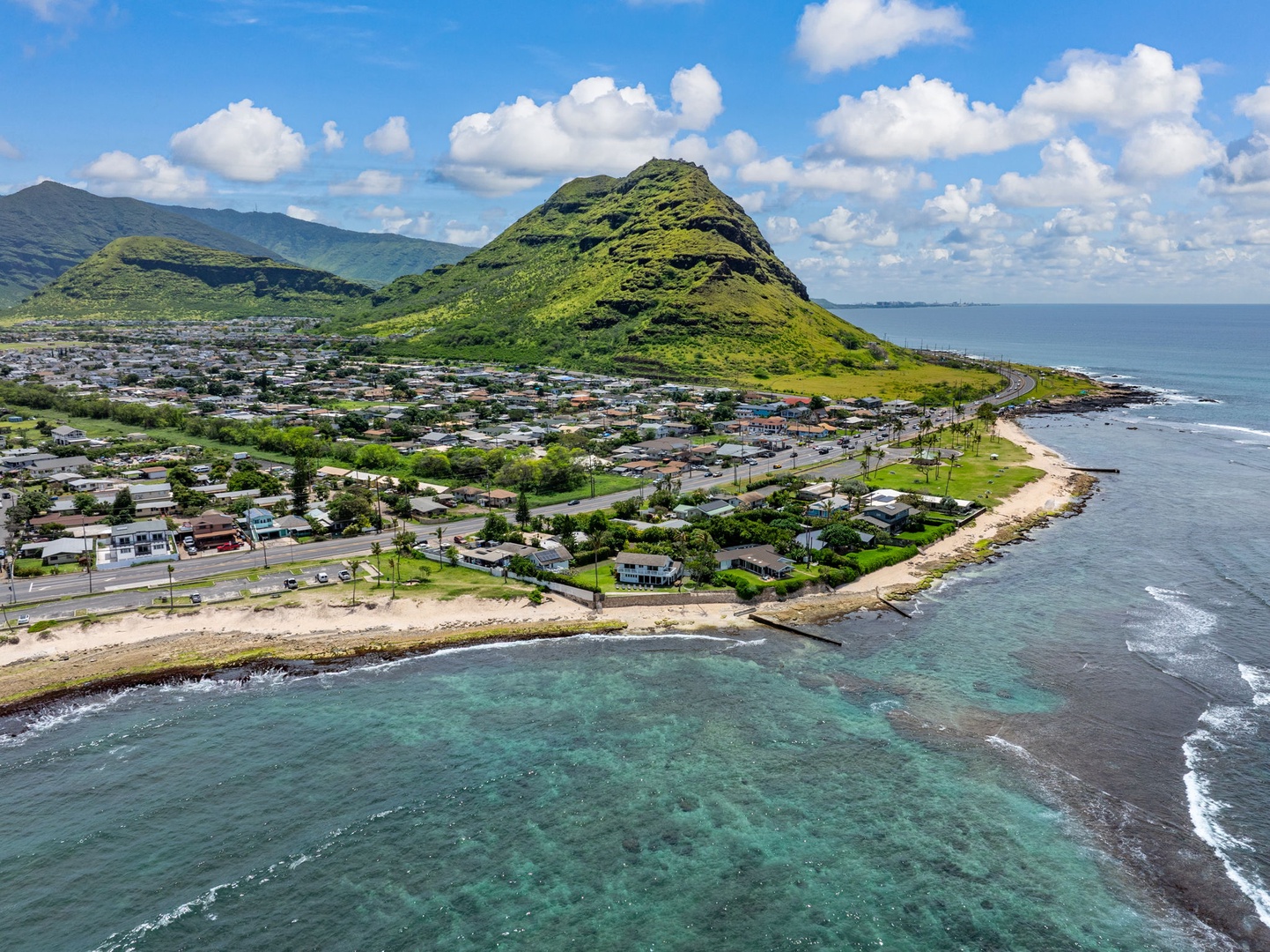 Waianae Vacation Rentals, Ma'ili Blue Estate - The aerial view showcases the dramatic volcanic landscape and pristine coastline surrounding this tropical destination.
