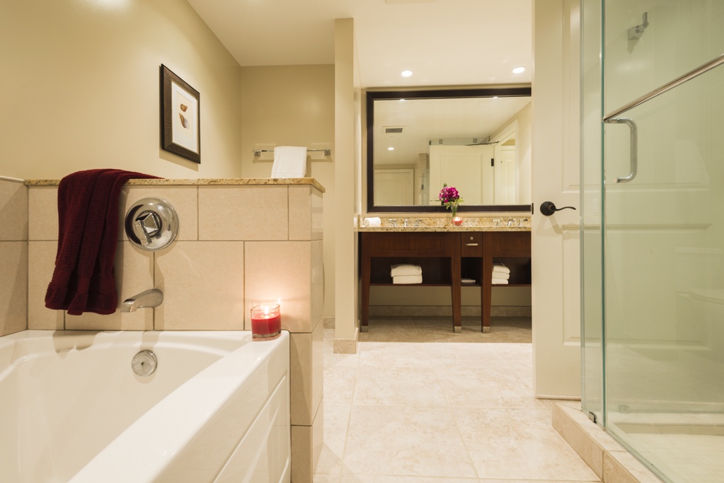 Lahaina Vacation Rentals, Honua Kai Hokulani 214 - The en-suite bathroom is elegantly designed, featuring a soaking tub and spacious vanity, creating a spa-like atmosphere for ultimate relaxation.