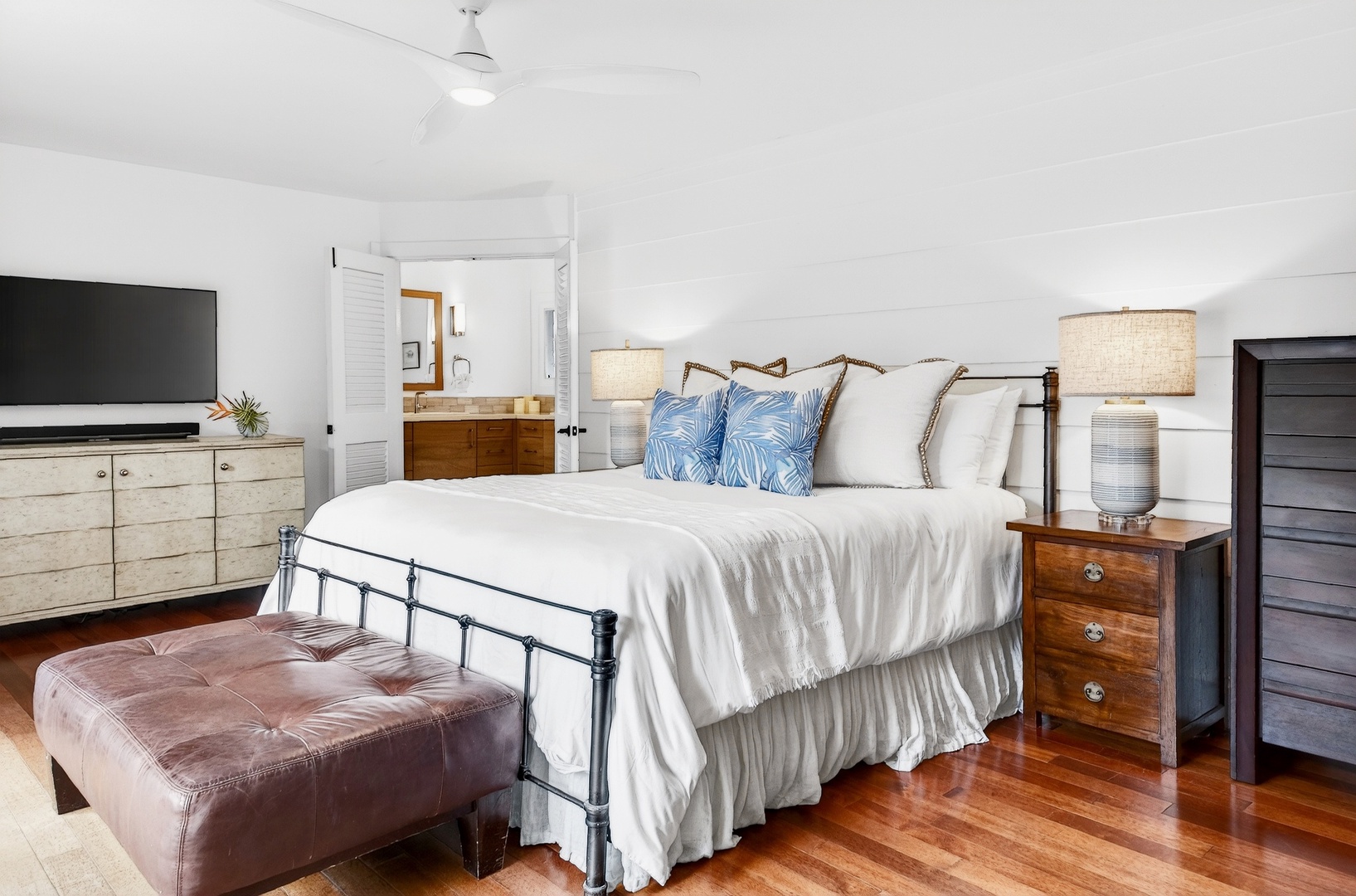 Kailua Vacation Rentals, Hale Ohana - Sink into crisp white linens and coastal blue accents in your serene bedroom retreat, complete with smart TV and warm wood floors.