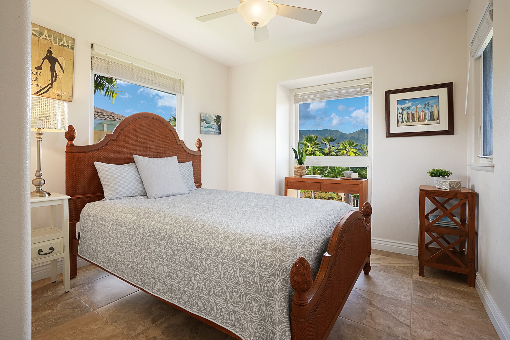 Princeville Vacation Rentals, Ku'u Lei Villa - The upstairs guest bedroom provides a cozy retreat with a queen-sized bed and views of the lush surroundings.