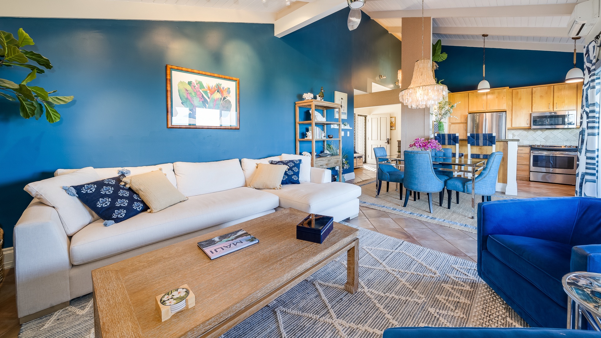 Kihei Vacation Rentals, Wailea Ekolu 1106 - A cozy living room with a large sofa, a bright blue accent wall, and plenty of natural light