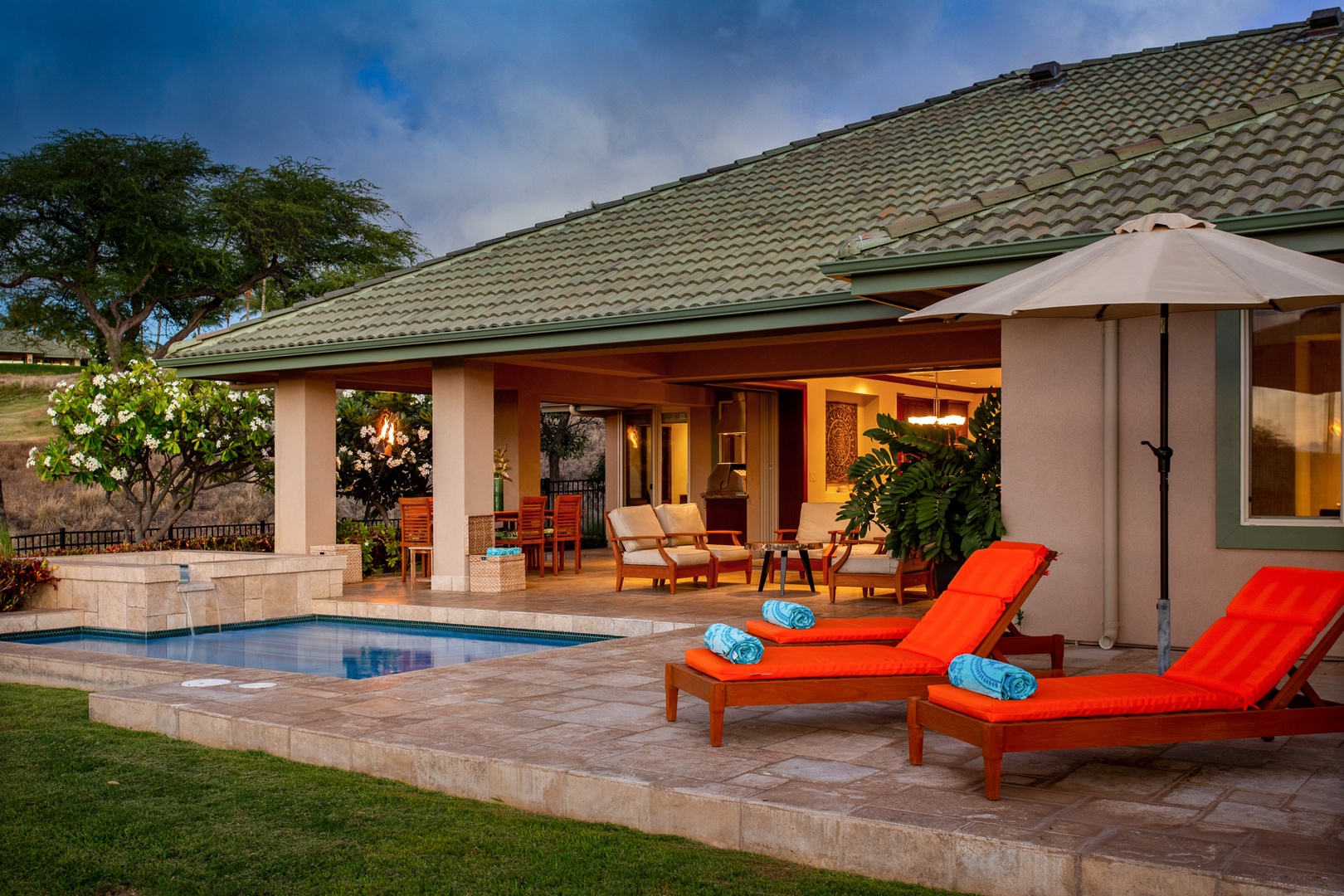 Kamuela Vacation Rentals, 3BD Wai'ula'ula Villa (312) at Mauna Kea Resort - Expansive outdoor living space framed by tropical foliage and views of the golf course and sea.