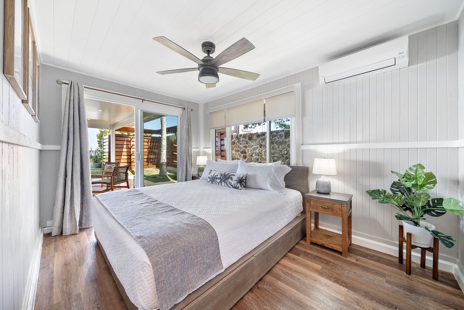 Haleiwa Vacation Rentals, Hale Nalu (Lower Level) - Natural light and coastal charm greet you in the lower-level primary suite with ceiling fan and sliding doors.