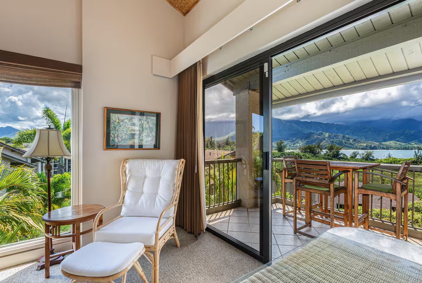 Princeville Vacation Rentals, Hanalei Bay Resort 4301/2/3 - Cozy sitting area with access to the balcony and stunning mountain vistas. – Ideal for relaxing or reading with picturesque views.