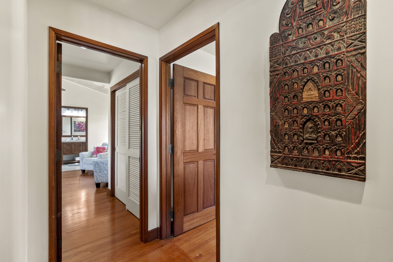 Haleiwa Vacation Rentals, Maluhia Beach House - A bright hallway leading to private retreats, featuring island-style artwork and warm wood accents.