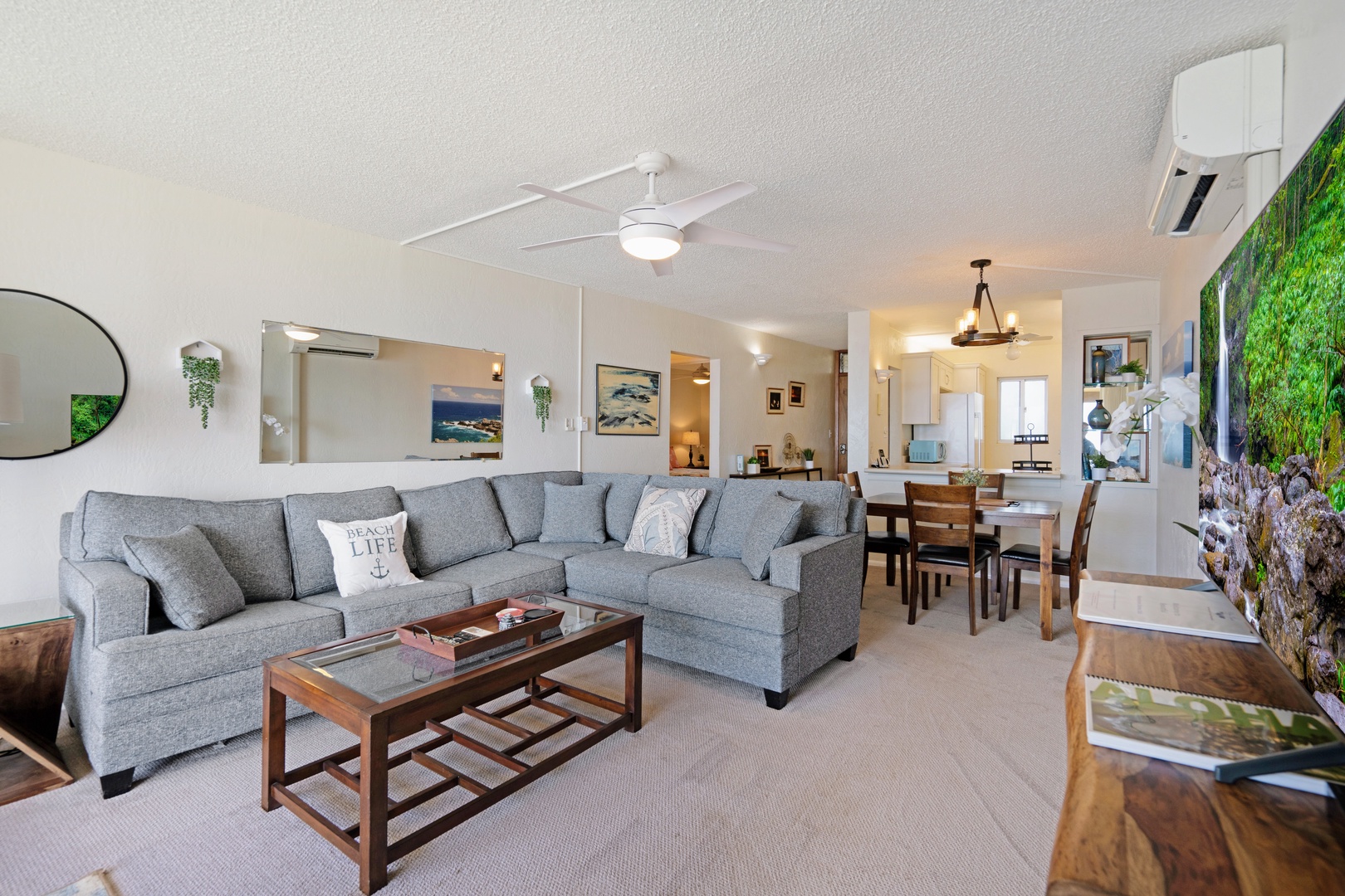 Kihei Vacation Rentals, Menehune Shores 316 - An ALOHA coffee-table book sits between the sectional and the dining table, where the group always ends up.