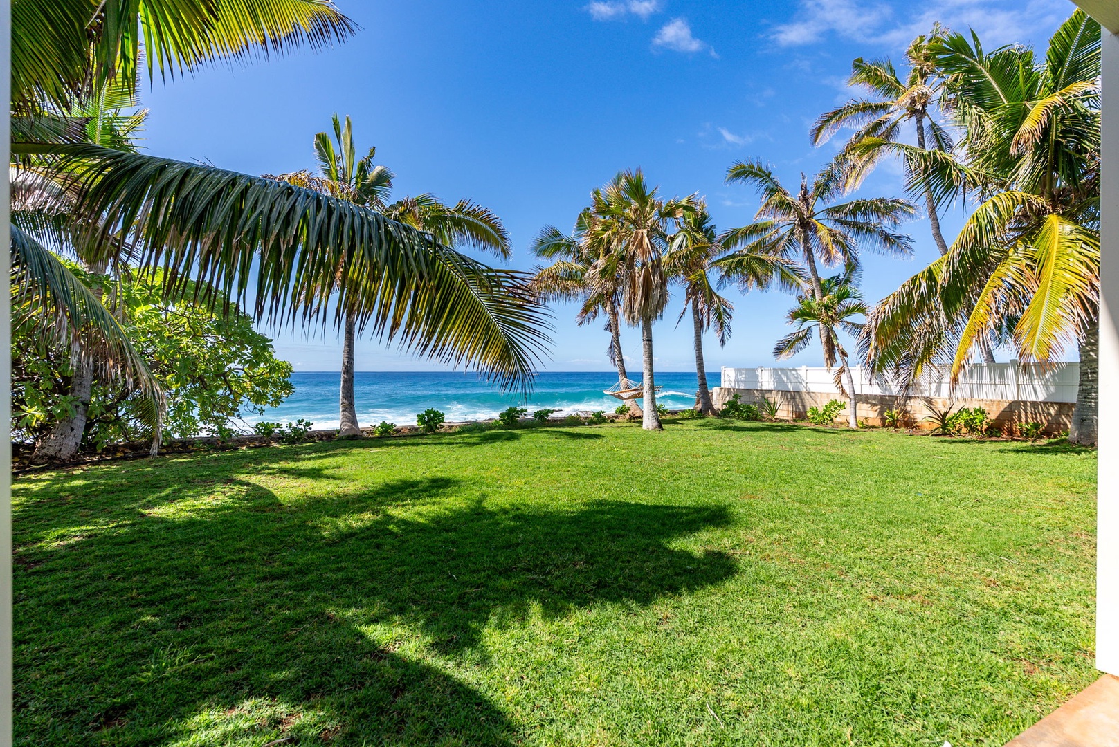 Waianae Vacation Rentals, Oceanfront Luxury Dream Estate - Expansive lawn meets the Pacific—a stunning green space just steps from the surf.