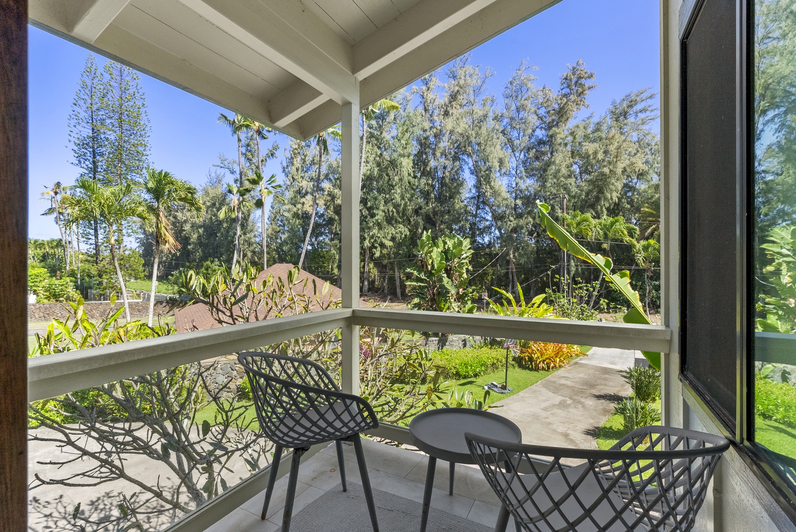 Haleiwa Vacation Rentals, Maluhia Beach House - Relax on the queen bedroom lanai with garden views and a peaceful seating area for morning coffee.