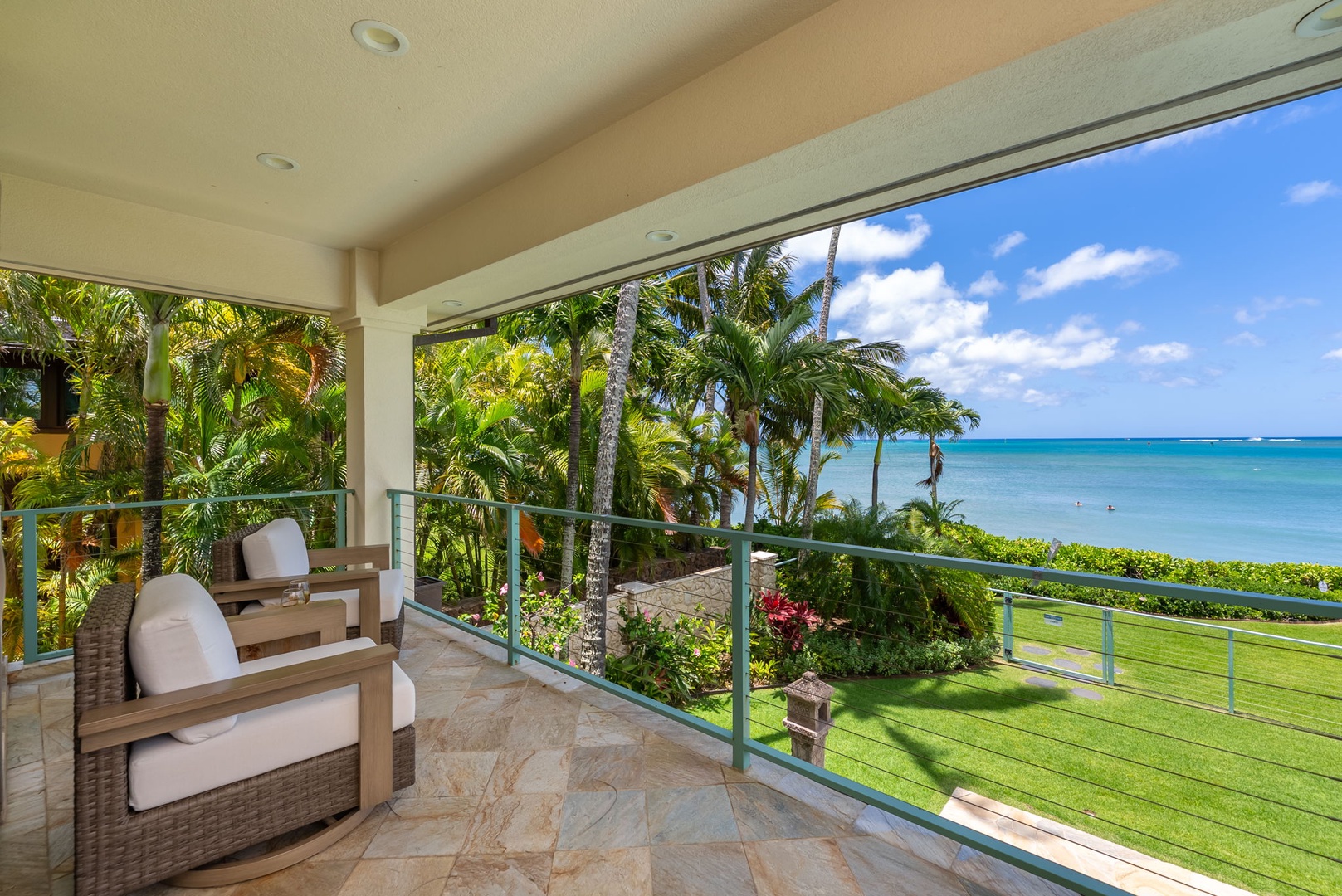 Honolulu Vacation Rentals, Maunalua Estate - Ocean breezes and swaying palms frame this open-air lounge with sweeping coastal views.