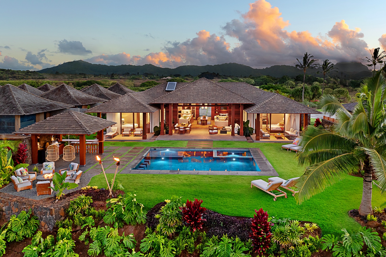 Koloa Vacation Rentals, Hale Ka Pua Ola at Kukuiula - Sunset aerial shot highlighting the luxurious home and its inviting pool area.