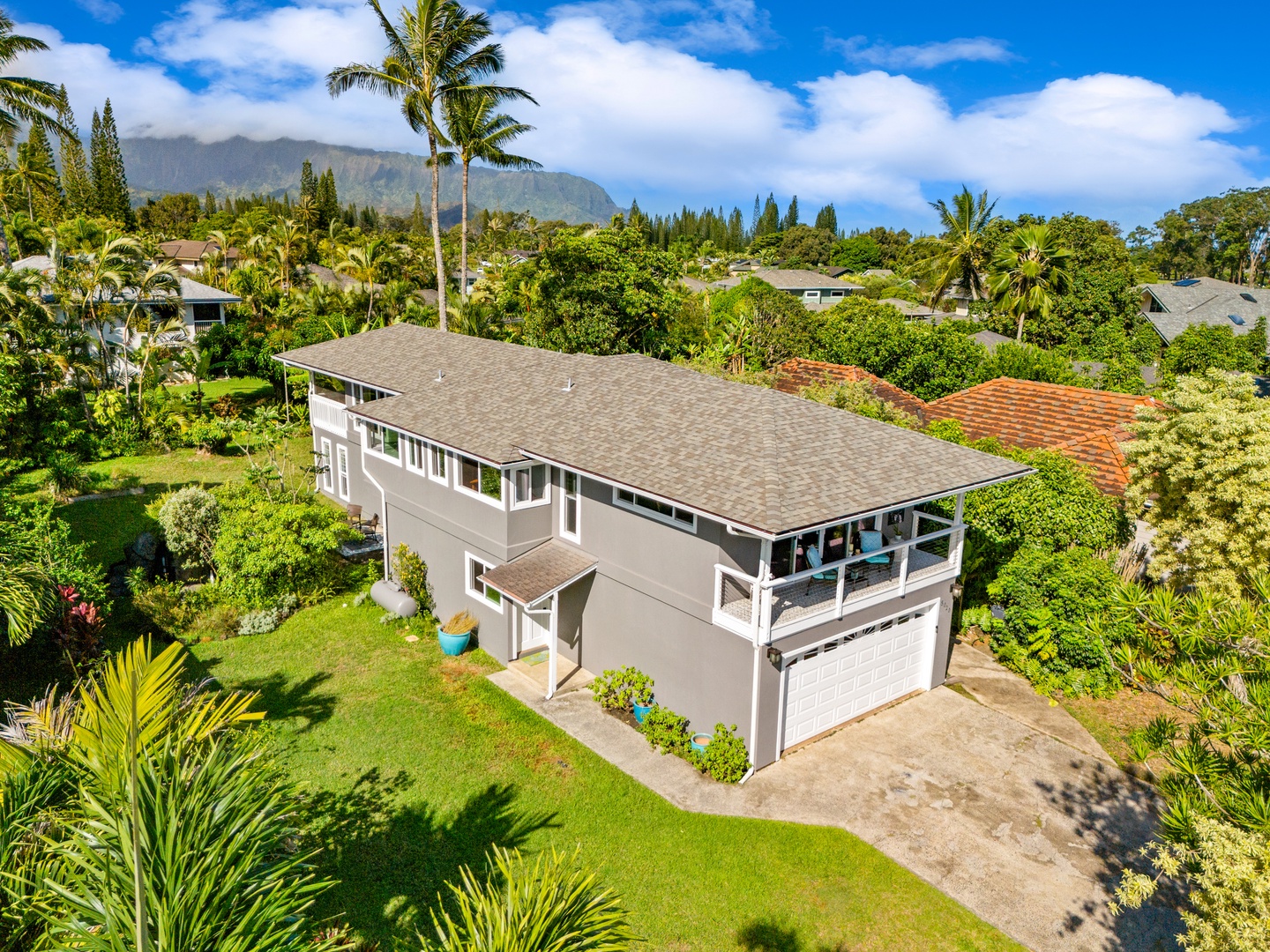 Princeville Vacation Rentals, Ola Hou - Entire Property - See the home from above, surrounded by trees and mountains.