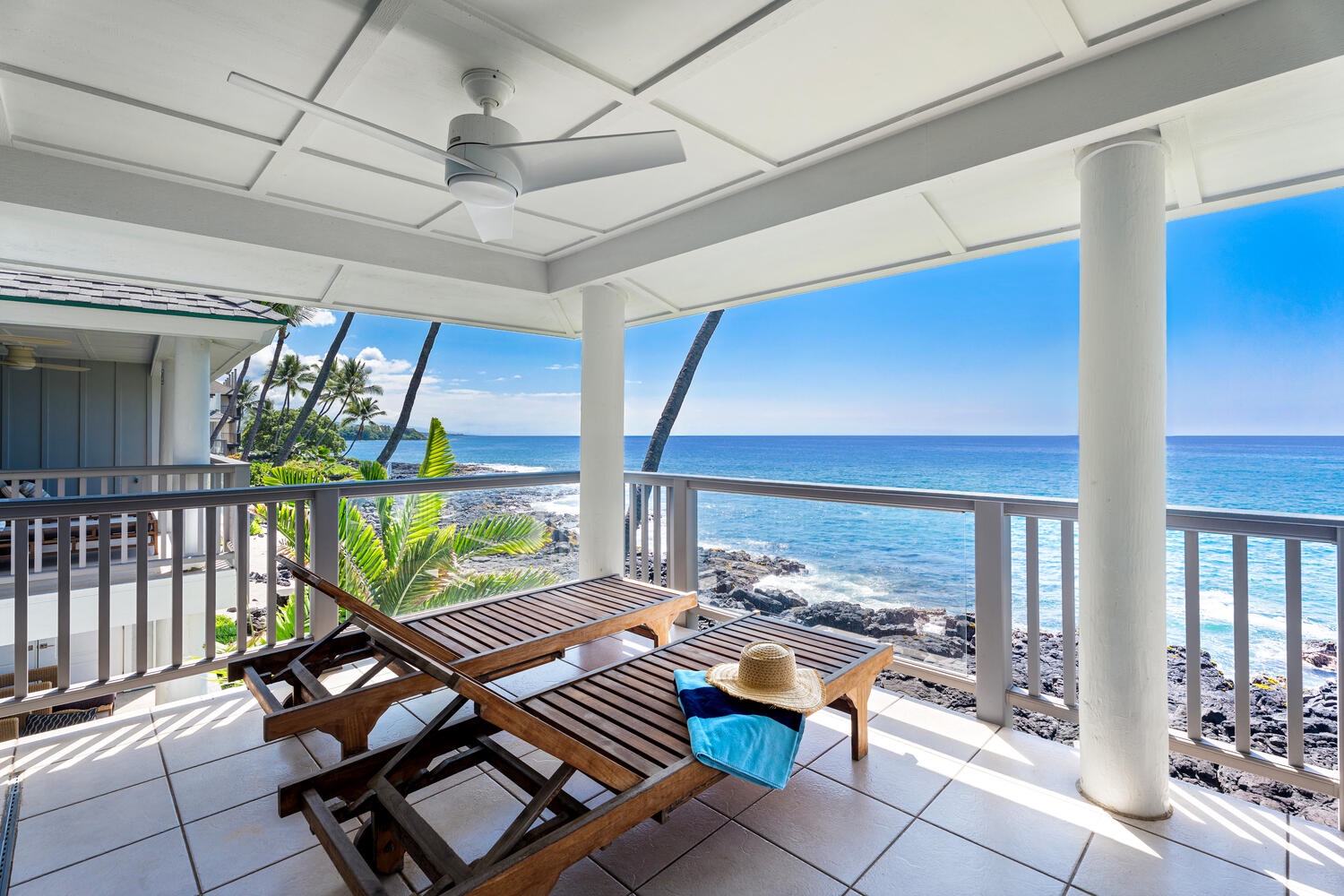 Kailua Kona Vacation Rentals, Hale Kai O'Kona #7 - Upper-level private lanai with lounge chairs overlooking the breathtaking Kona coastline.