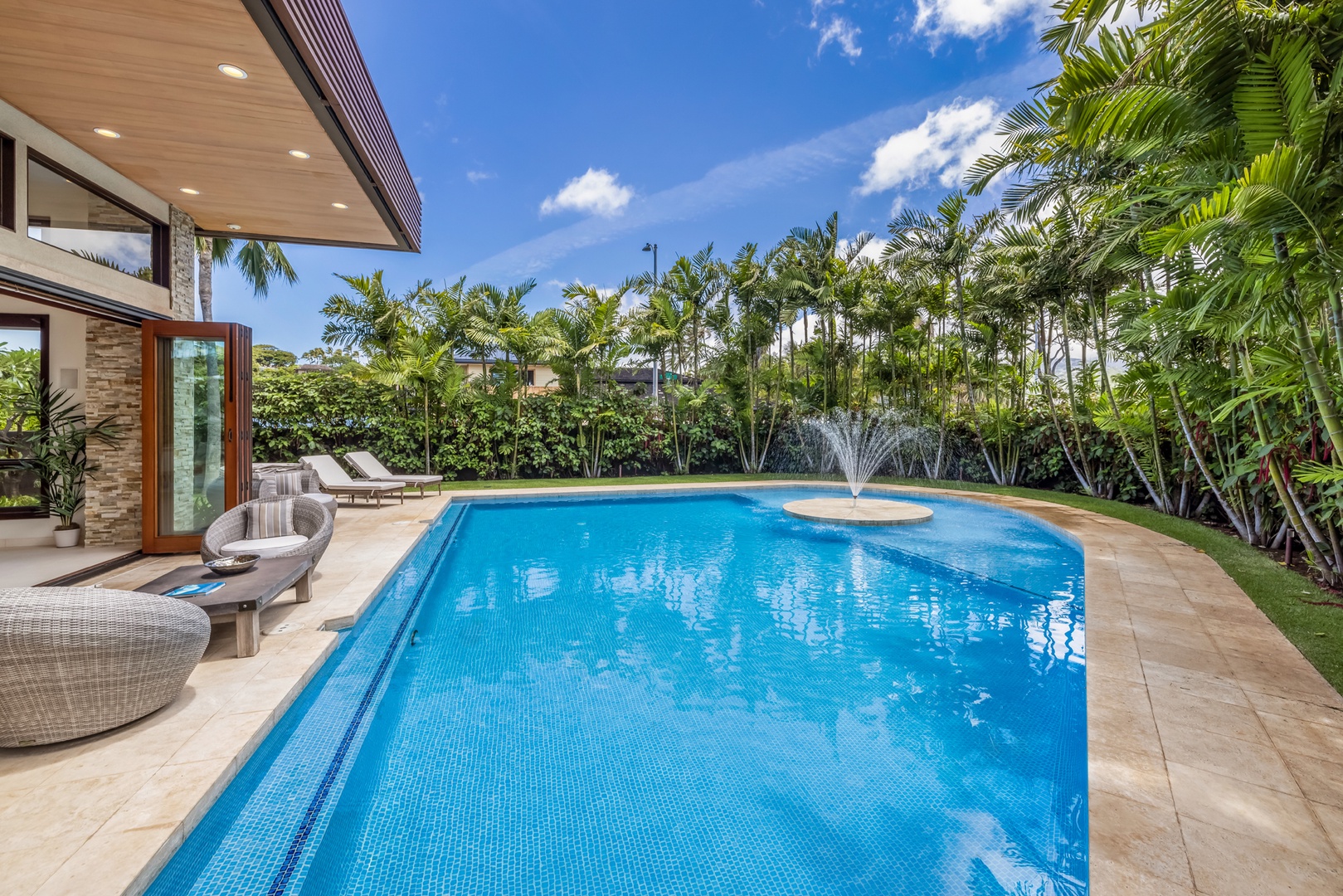 Honolulu Vacation Rentals, Kahala Grand Splendor - Enjoy a refreshing swim in the crystal-clear pool, surrounded by lush tropical greenery.