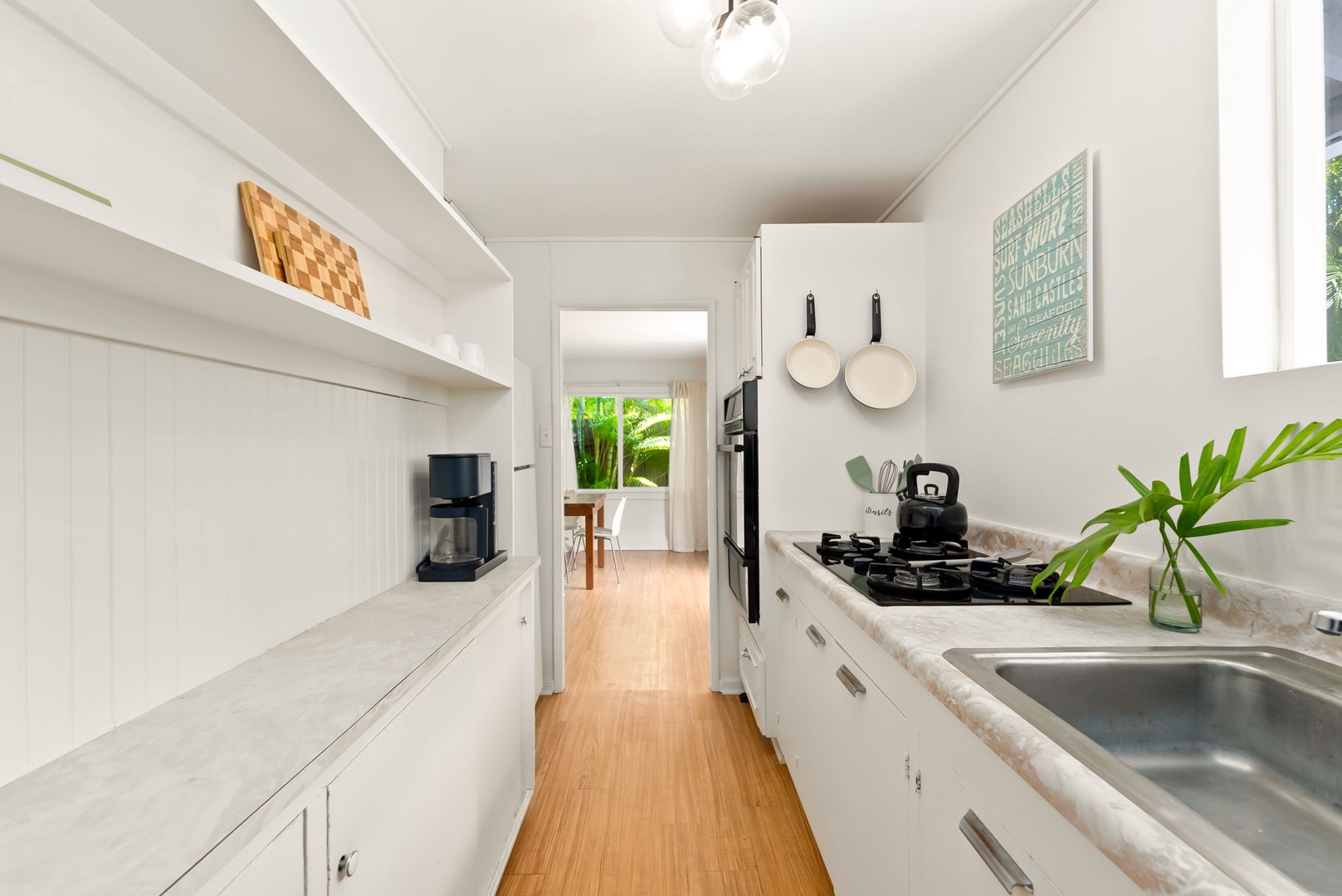 Honolulu Vacation Rentals, Ho'okipa Villa - Your own bright, fully-equipped kitchen invites you to prepare fresh meals, with modern appliances and all the essentials at your fingertips—perfect for relaxing mornings or easy family dinners.