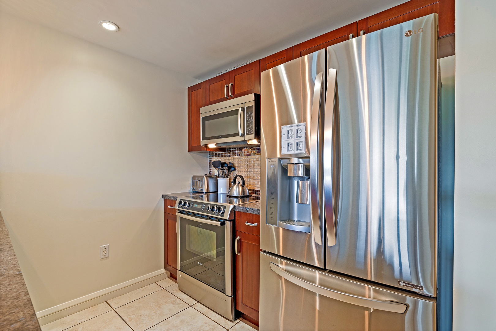 Lahaina Vacation Rentals, Honua Kai Konea 206 - The kitchen is equipped with sleek stainless steel appliances, including a modern refrigerator and stove, providing everything you need to prepare meals during your stay.