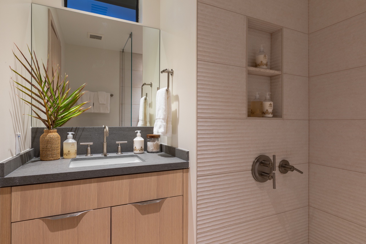 Waimea Vacation Rentals, 5BD Mauna Lani Lux Golf Estate (4) at One Ocean - This elegantly designed bathroom features a modern vanity with a sleek wooden base and a sophisticated countertop.