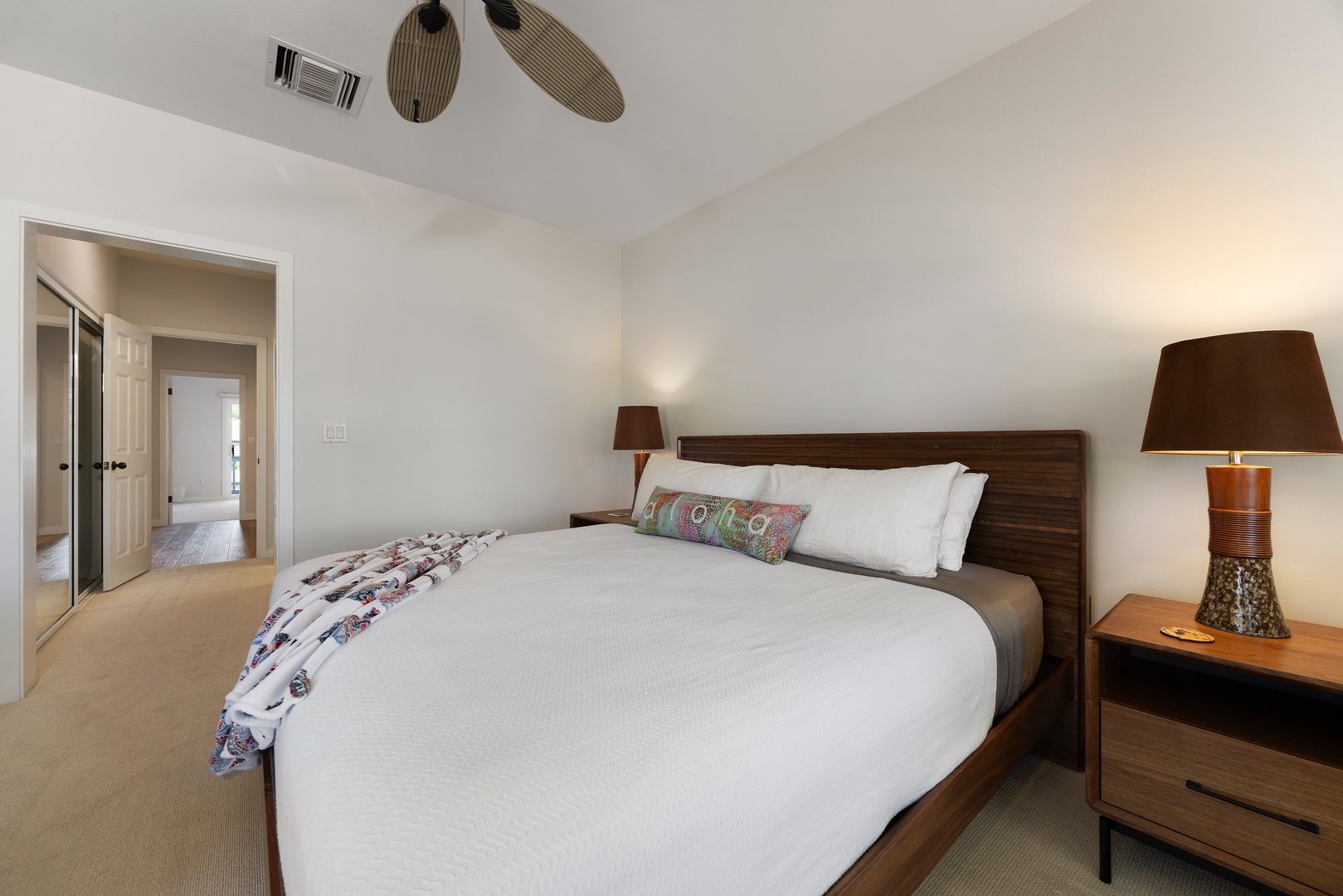 Drift off in this serene bedroom where crisp linens and warm wood tones create your perfect retreat.