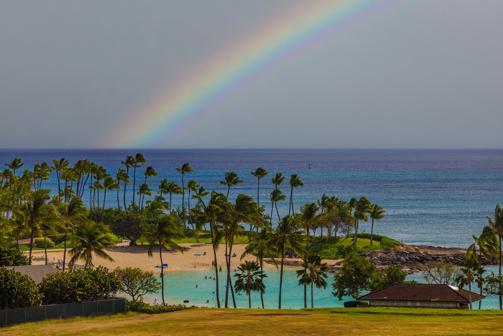 Kapolei Vacation Rentals, Ko Olina Beach Villas O724 - Rainbow arching over a tropical beachfront, a blend of nature's magic and tranquility.