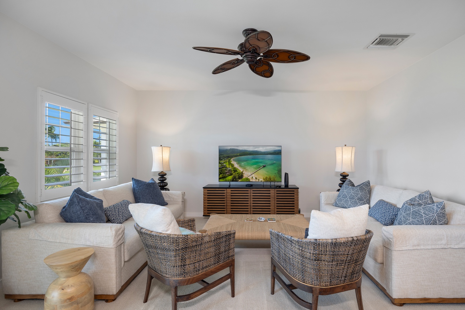 Sink into plush seating with tropical ocean views on your private TV, while the ceiling fan keeps you perfectly cool.