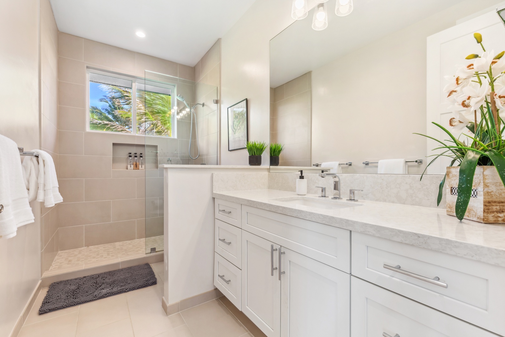 Laie Vacation Rentals, Majestic Mahakea Oceanfront Oasis - Sleek bathroom with a double vanity and a spa-inspired walk-in shower.