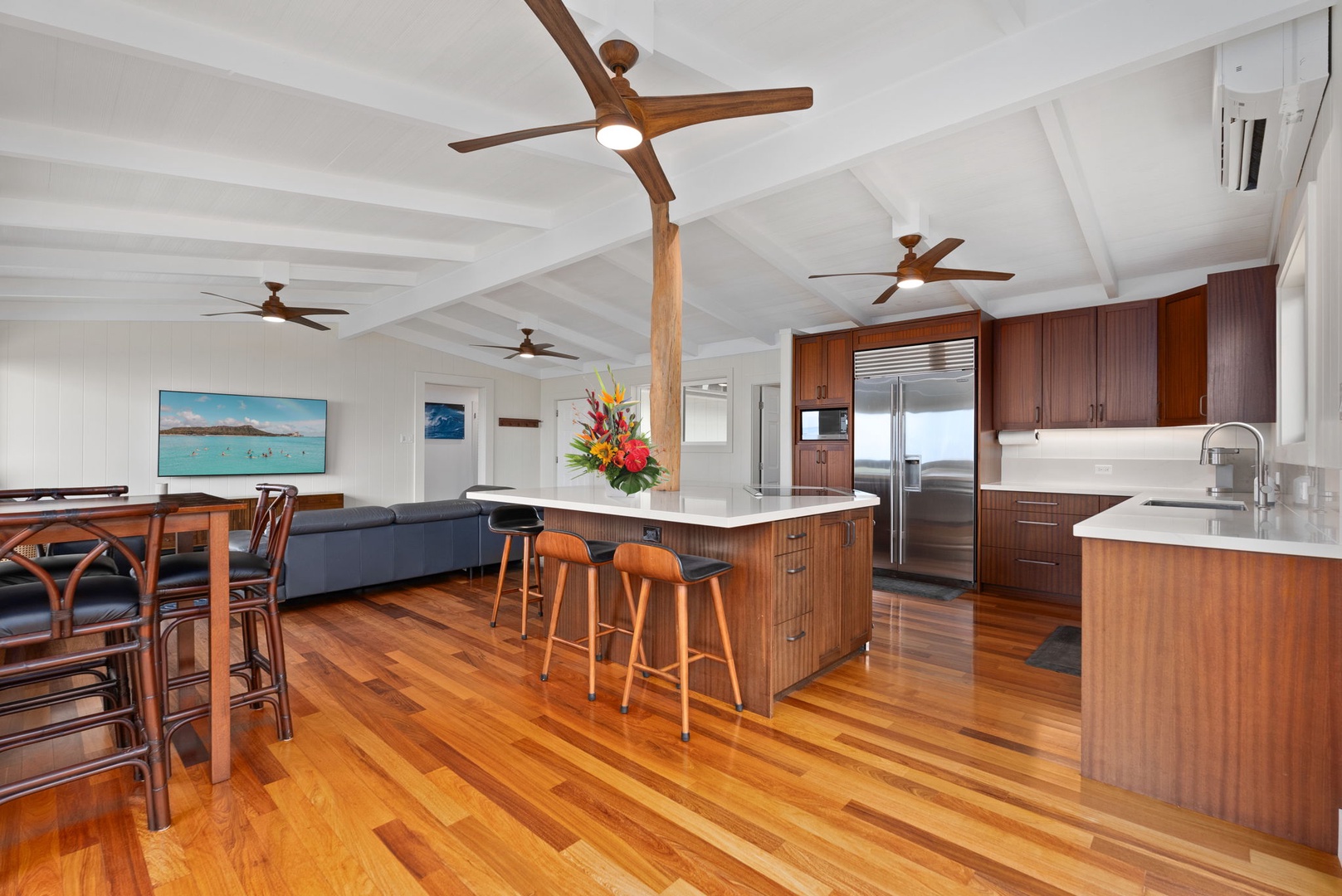 Waialua Vacation Rentals, Mokuleia Beach Villa** - Gather around the spacious kitchen island, perfect for casual meals or entertaining.