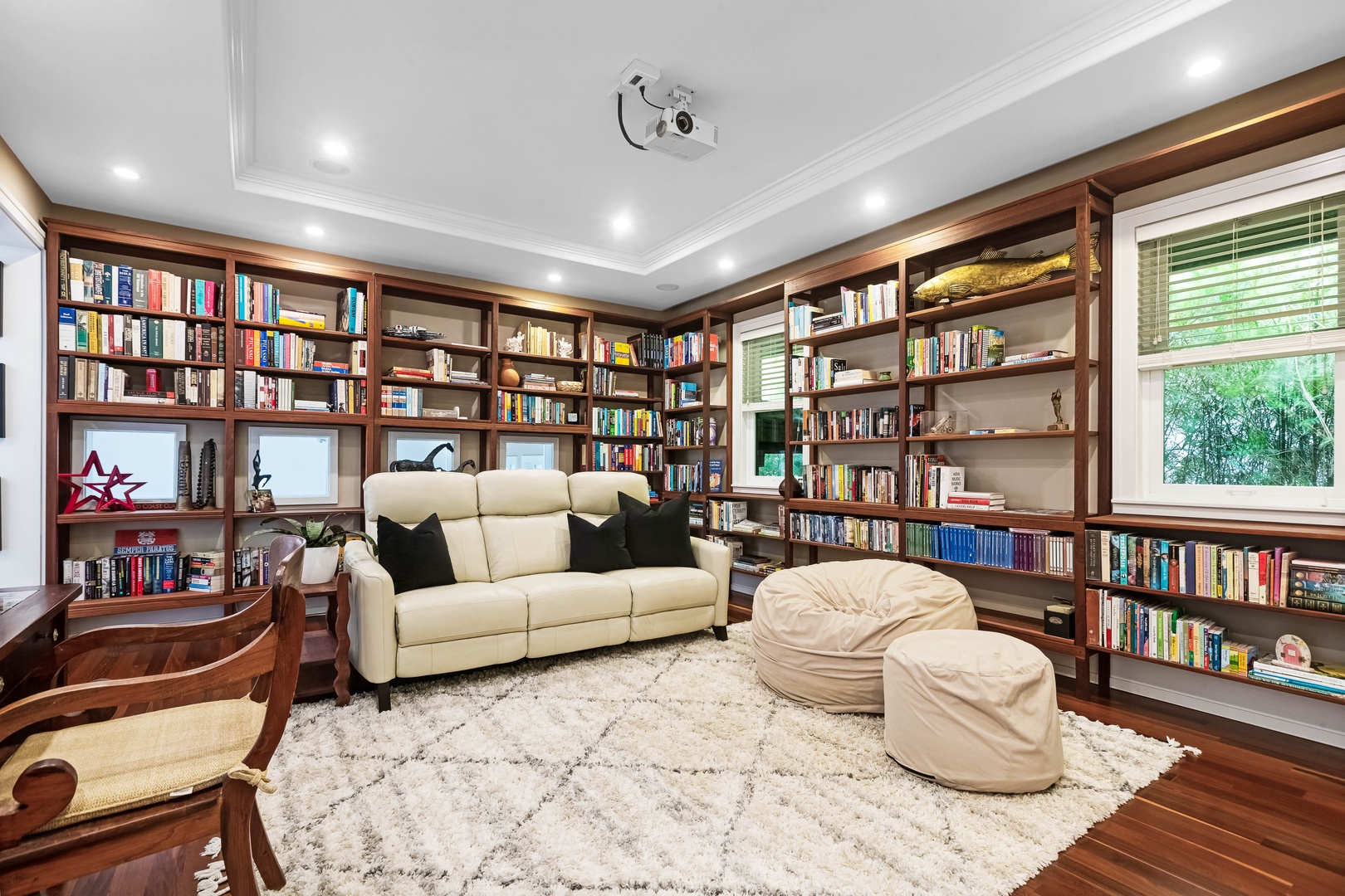 Honolulu Vacation Rentals, Pili Pono - Inviting library with cozy seating and floor-to-ceiling bookshelves.