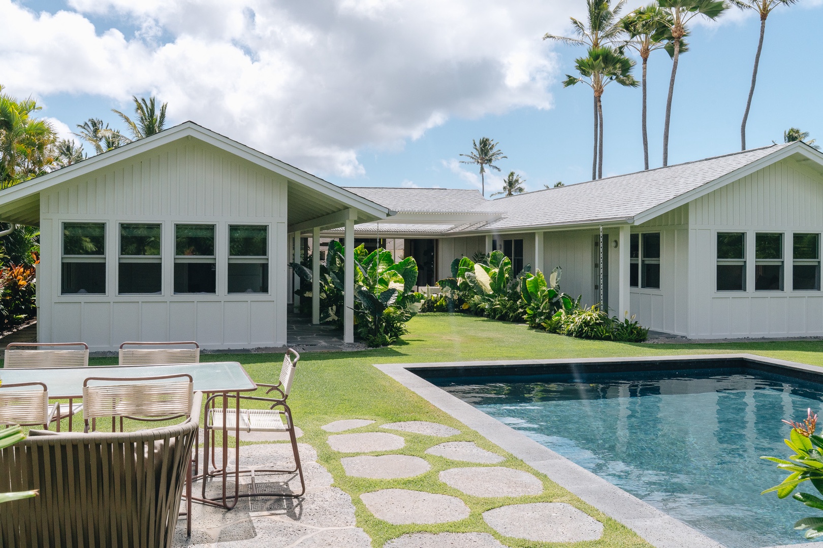 Honolulu Vacation Rentals, Surfside Bungalow** - Tropical landscaping surrounds the private pool, creating a serene outdoor retreat.
