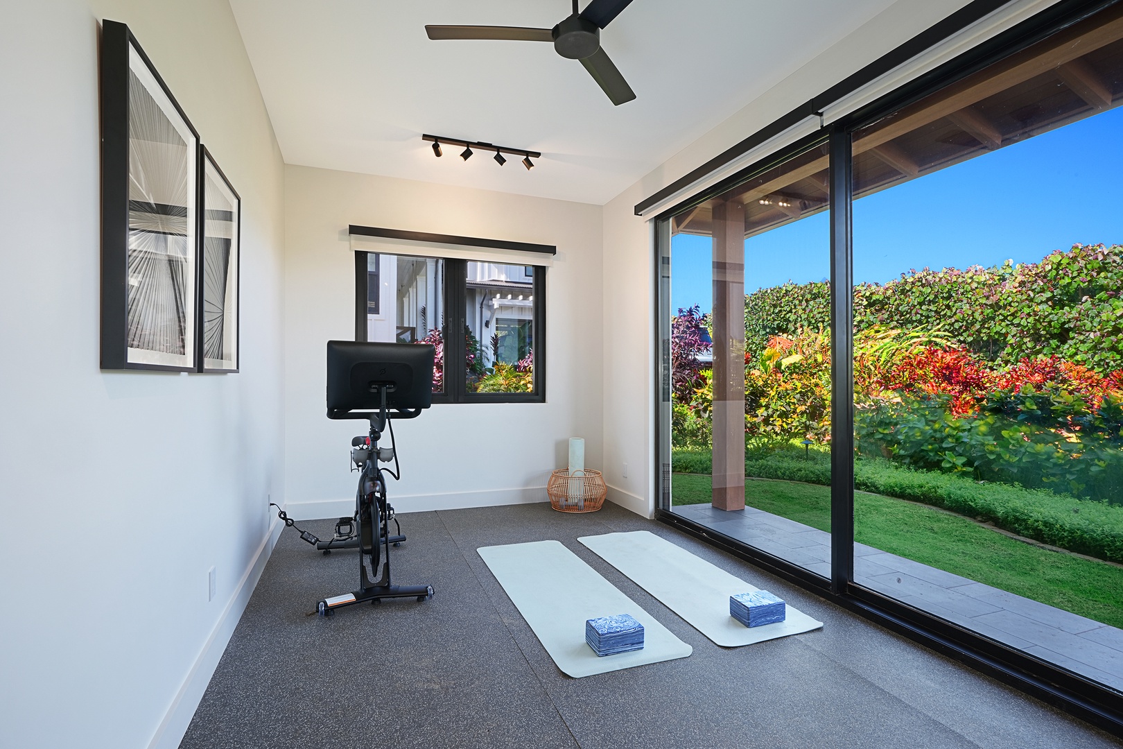Koloa Vacation Rentals, Hale Hanohano at Kukuiula - Dedicated exercise room with garden views and direct outdoor access—perfect for maintaining your wellness routine in paradise.