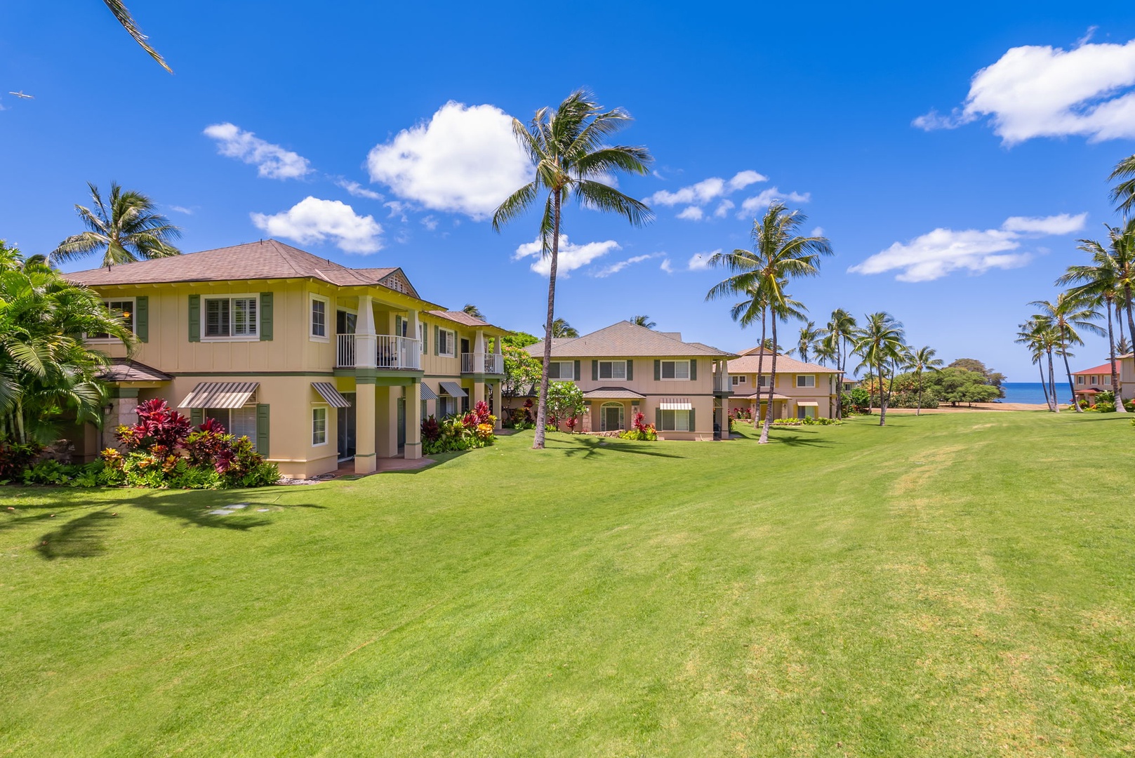 Kapolei Vacation Rentals, Kai Lani Luxury 6D - Expansive lawn area with swaying palm trees, offering a relaxing outdoor space with beautiful views.