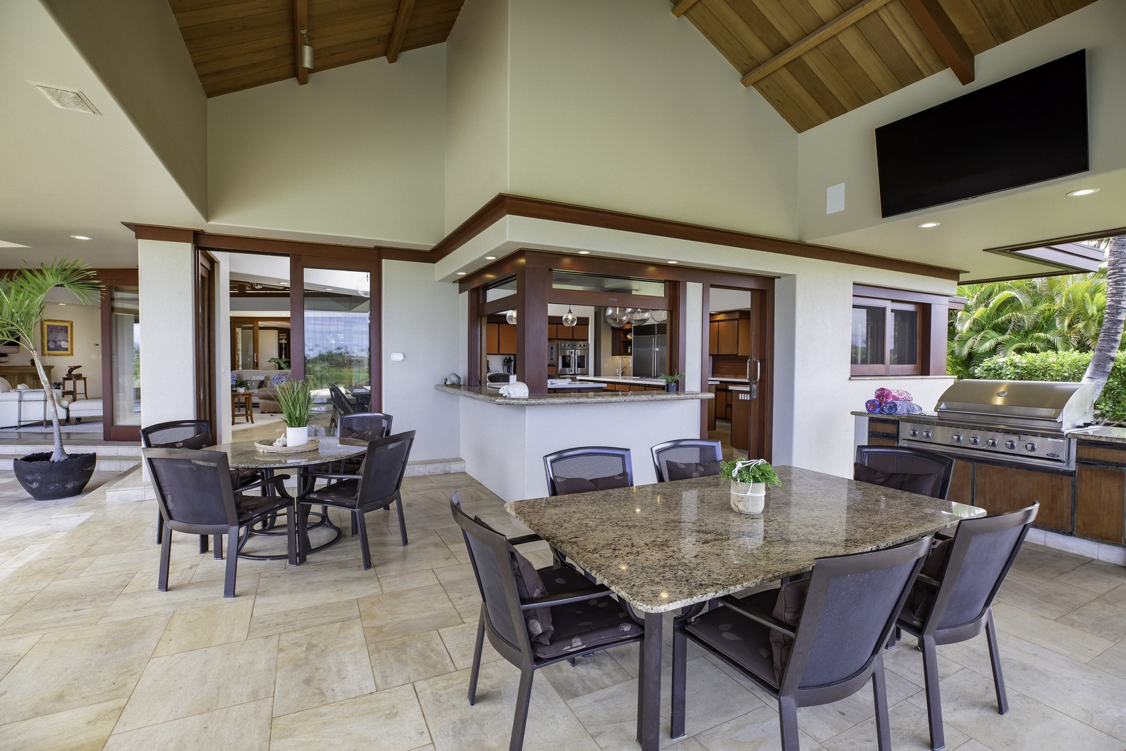 Kamuela Vacation Rentals, Champion Ridge 7 - Your open-air dining terrace seamlessly connects to a gourmet kitchen, where granite counters and premium appliances create the perfect space for entertaining.