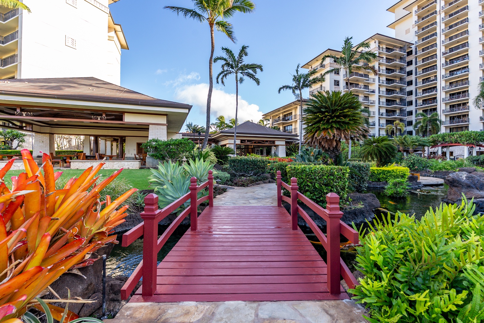 Kapolei Vacation Rentals, Ko Olina Beach Villas O1105 - Beds of tropical planting frame the bridge on the walk down.
