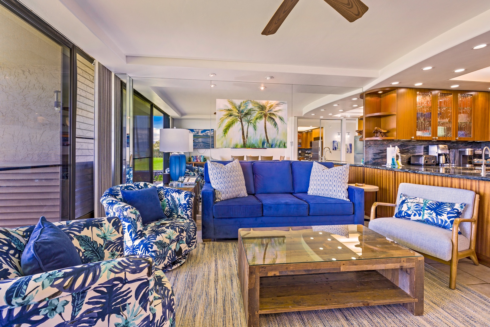 Lahaina Vacation Rentals, Papakea L-106 - The living area offers a comfortable retreat with a vibrant blue sofa and tropical accents