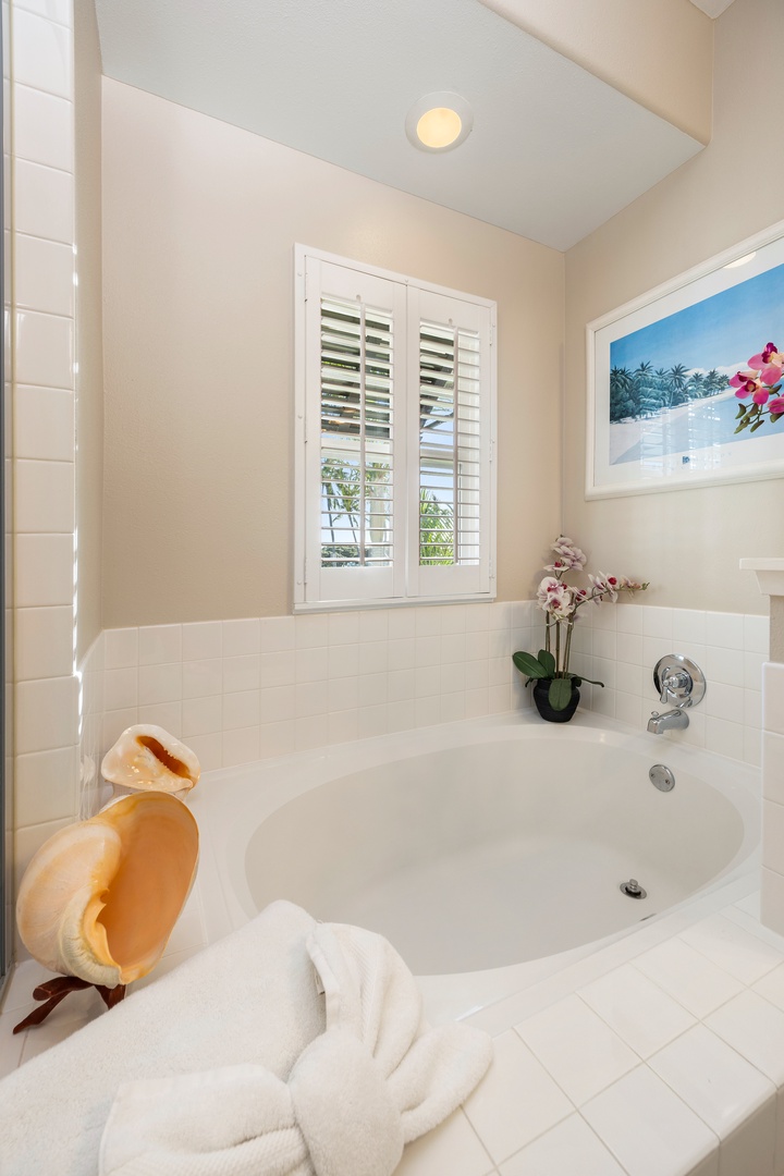 Unwind in your private soaking tub, surrounded by tropical touches and soft lighting for the perfect relaxation retreat.