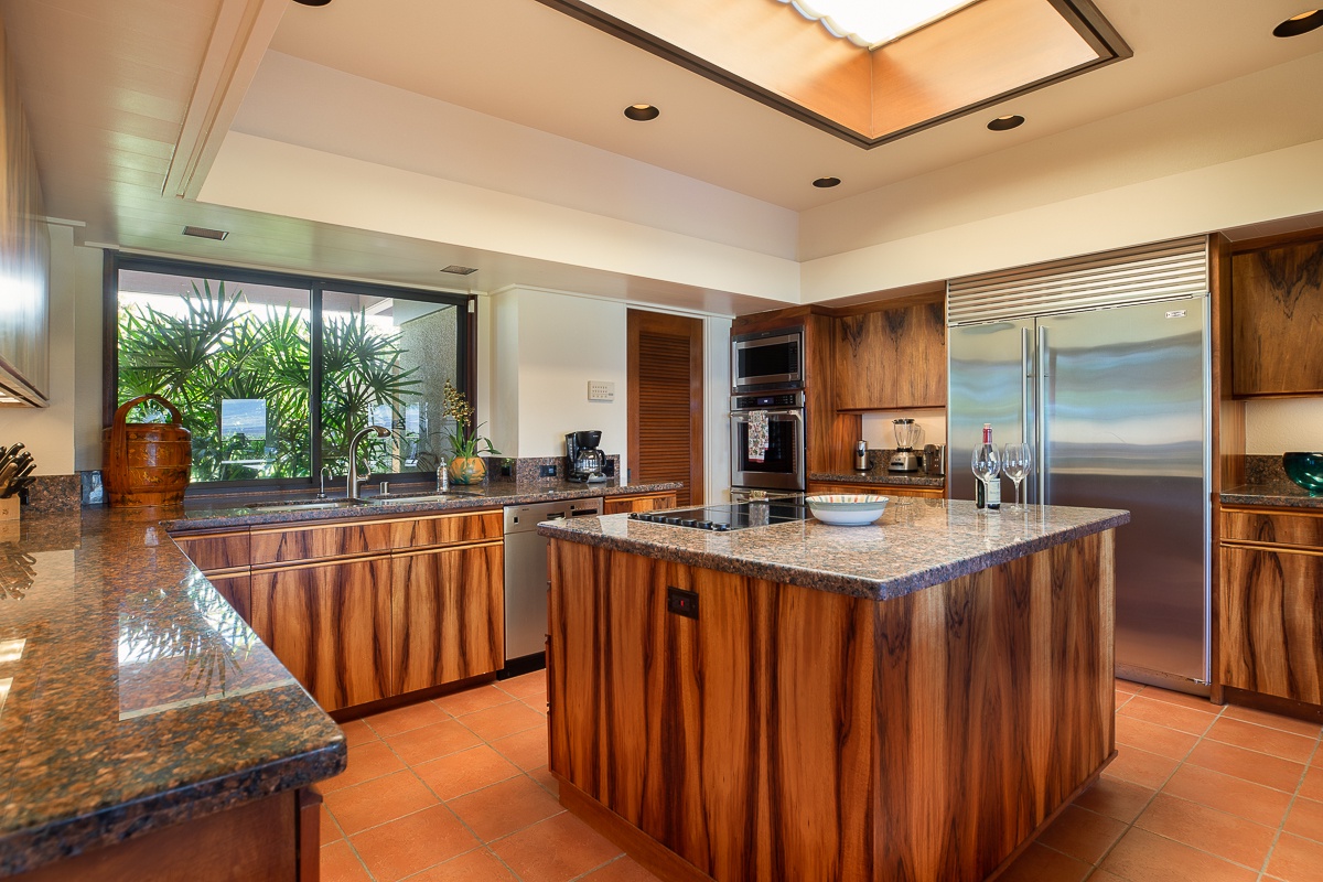 Kamuela Vacation Rentals, Mauna Kea Villas #13 - Gourmet kitchen with rich wood cabinetry, top-tier appliances, and ample counter space.