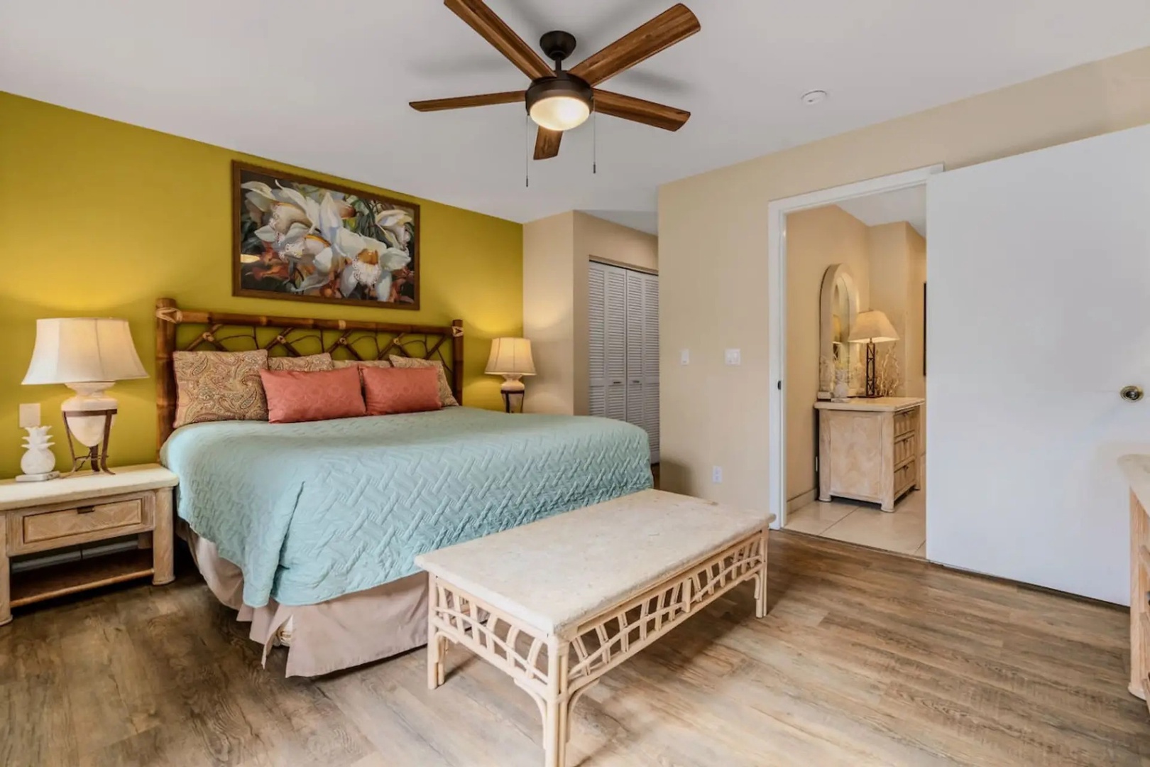 Kihei Vacation Rentals, Maui Kamaole E103 - Closet space and a quiet mustard accent wall give the primary suite its own settled, private feel.
