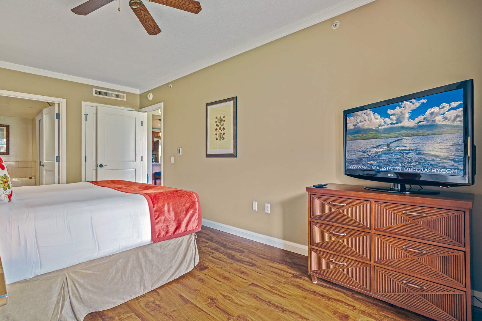 Lahaina Vacation Rentals, Honua Kai Konea 204 - A comfortable bedroom with a king-sized bed convertible to twin beds, flat-screen TV, and wood flooring, providing a cozy retreat after a day of exploring.