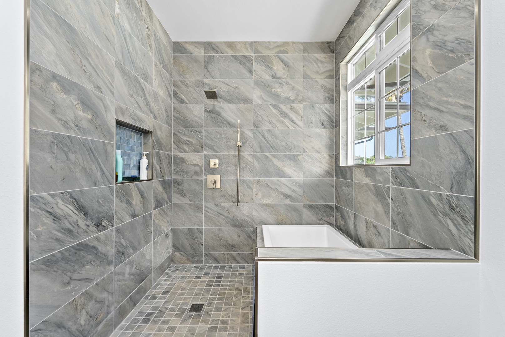Waianae Vacation Rentals, Oceanfront Luxury Dream Estate - Stone-style tile and window-side soaking tub blend spa luxury with breezy island charm.