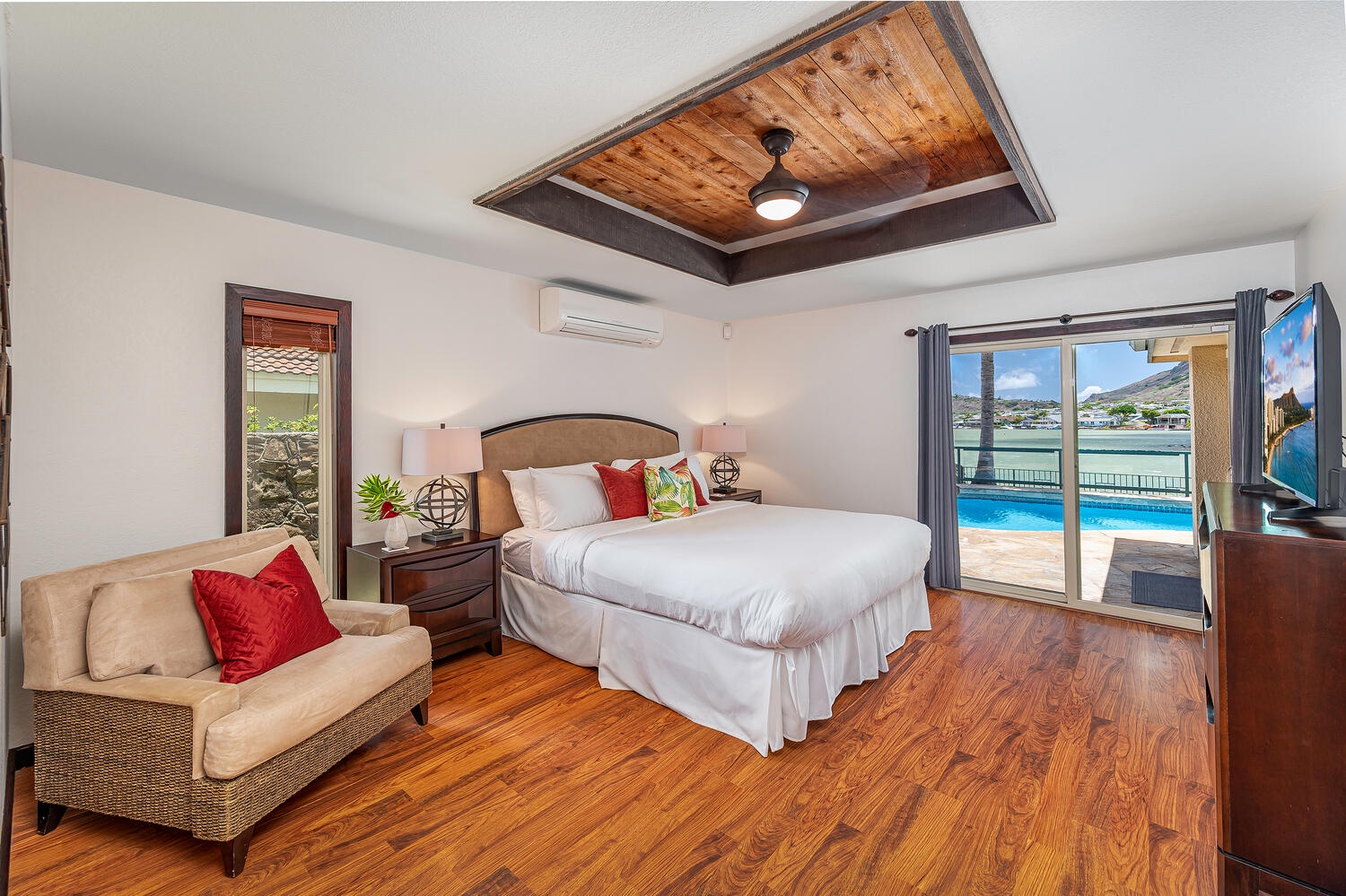 Honolulu Vacation Rentals, Nani Wai - Primary bedroom with marina and pool view and its own ensuite and walk in closet.
