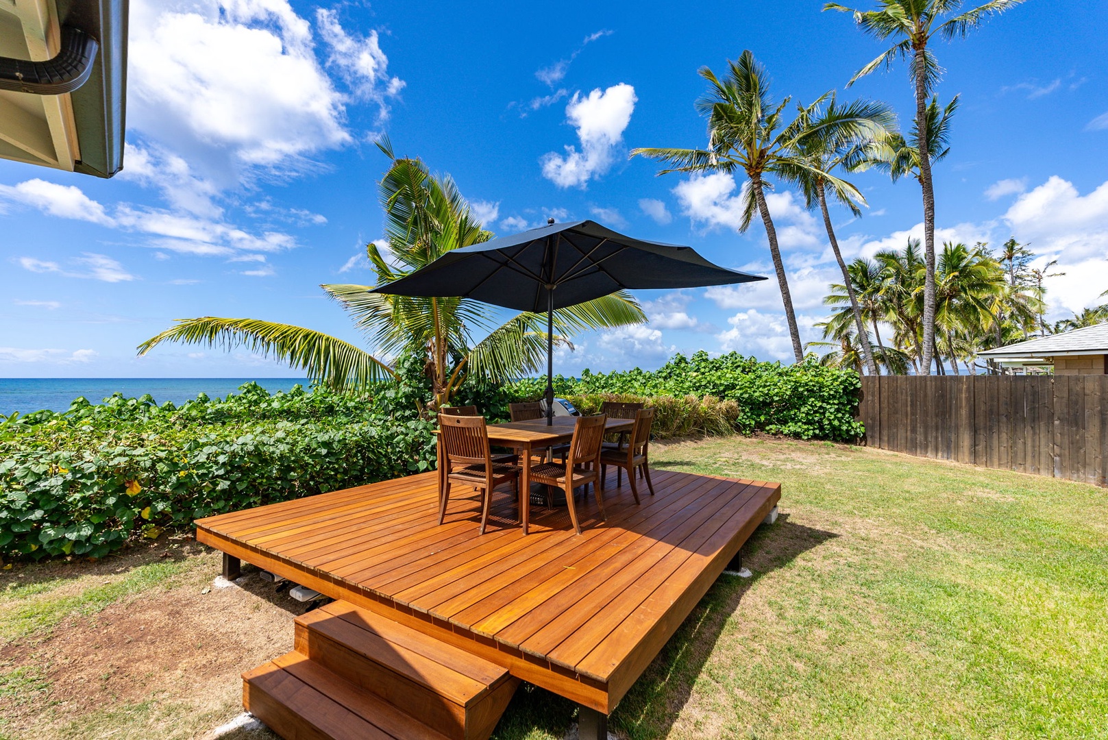 Waialua Vacation Rentals, Mokuleia Beach Villa** - Dine al fresco with a view on the deck with outdoor seating.