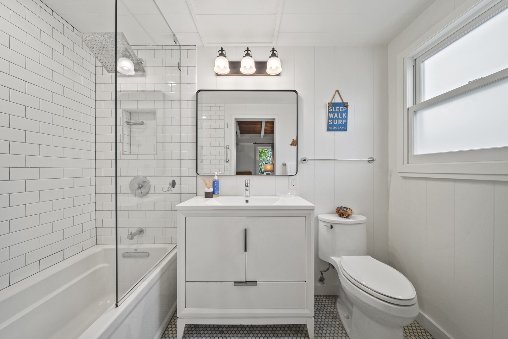 Haleiwa Vacation Rentals, Surfer's Paradise - Ensuite bathroom featuring a modern vanity and bright lighting—ideal for refreshing after beach days or surf sessions.
