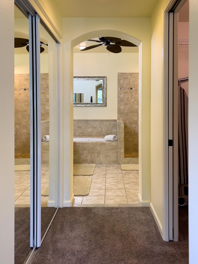 Kamuela Vacation Rentals, Mauna Lani Fairways #204 - Spacious ensuite bath with dual sinks, glass walk-in shower, and soaking tub—your private in-home spa experience.