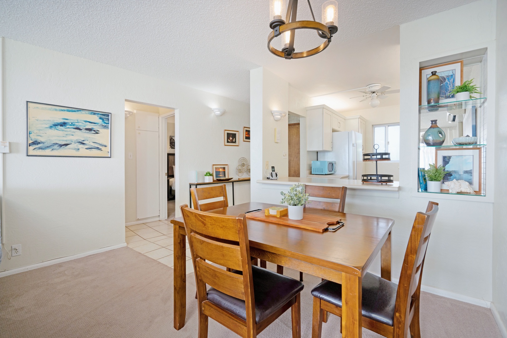 Kihei Vacation Rentals, Menehune Shores 316 - Pull up one of four chairs at the table, kitchen and its turquoise microwave just behind you.