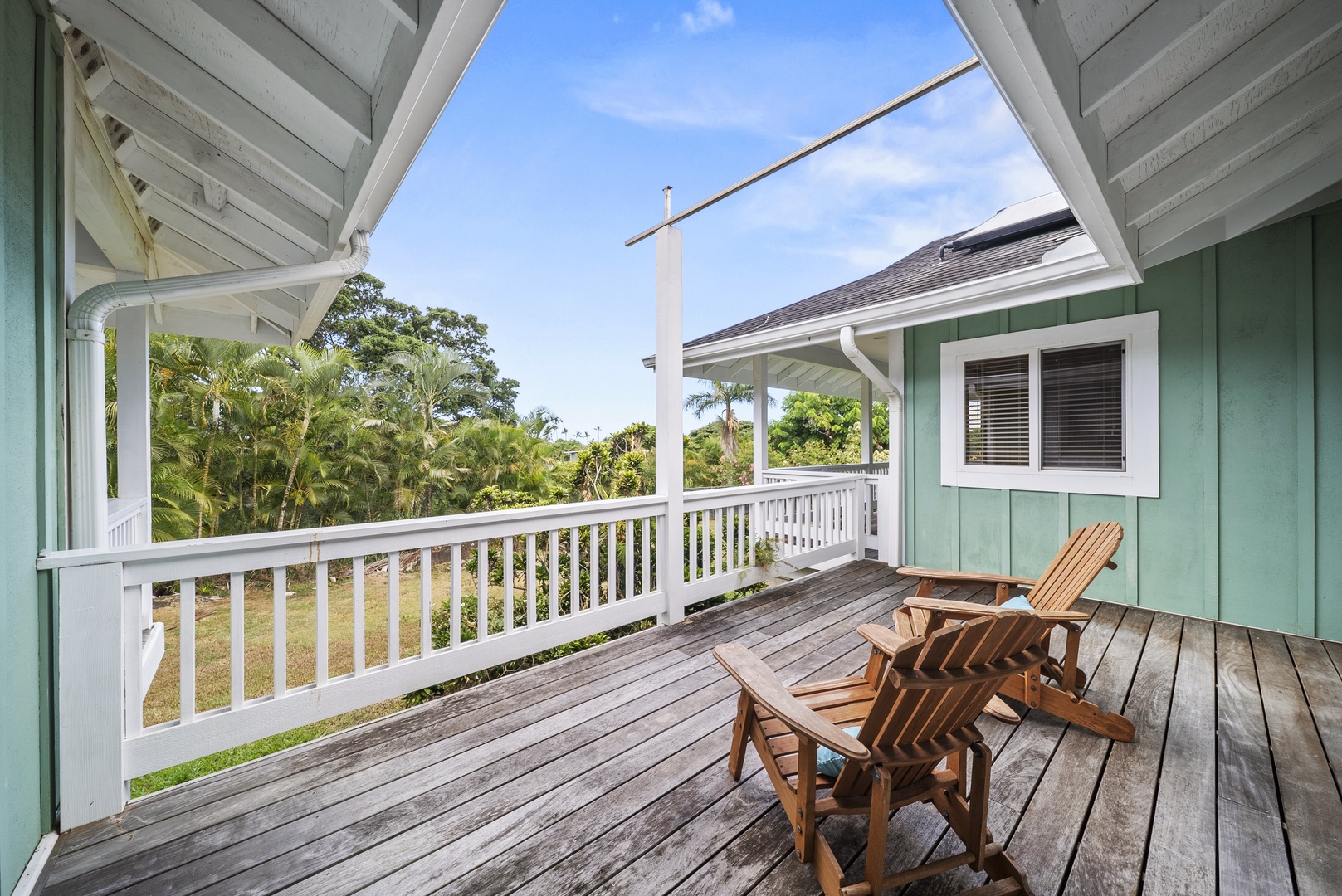Haleiwa Vacation Rentals, North Shore Tropical Hale - Private upper-level lanai with comfortable seating—ideal for morning coffee, afternoon reading, or simply soaking in the tropical views and gentle breezes.