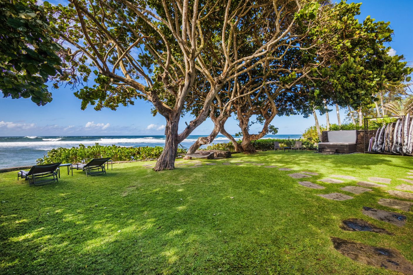 Haleiwa Vacation Rentals, Sunset Point Hawaiian Beachfront** - Shades of trees in the backyard to soothe the island summer heat.