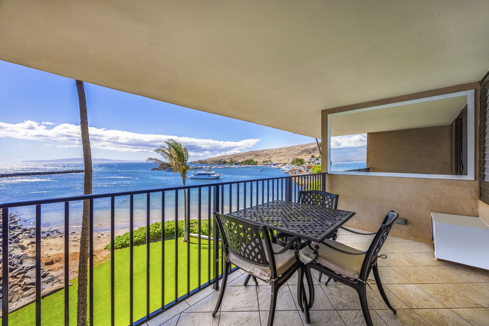 Wailuku Vacation Rentals, Milowai 310 - By day the lanai table seats three, with the green lawn and the marina both in view.