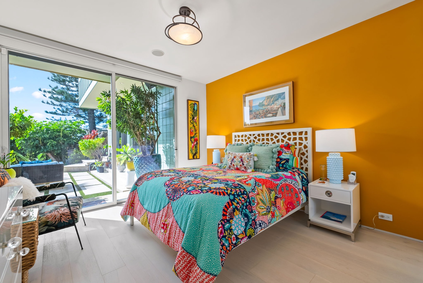 Honolulu Vacation Rentals, Kahala Hills Estate - Guest suite with bold tropical tones, private lanai access, and ocean views.