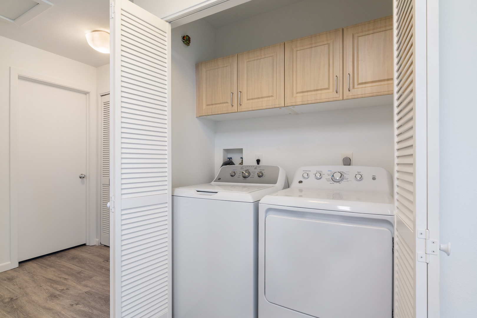 Kapolei Vacation Rentals, Fairways at Ko Olina 7A - Your dedicated laundry nook keeps your vacation wardrobe fresh with convenient in-unit washer and dryer plus thoughtful storage above.