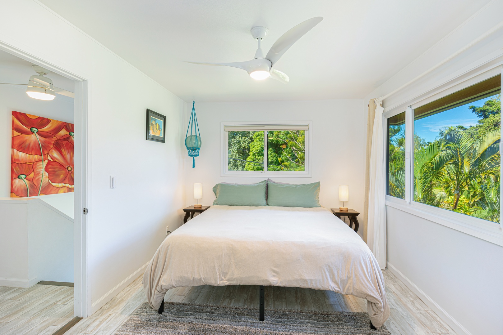 Princeville Vacation Rentals, Pohaku Kauai - Primary bedroom with King bed, Central A/C, ceiling fan, and lush tropical views.
