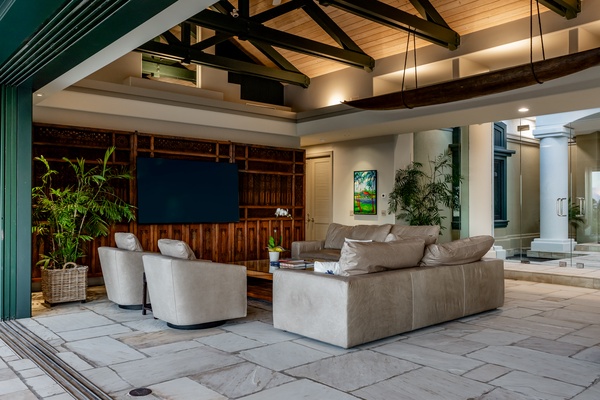 Kamuela Vacation Rentals, Canoe House & Beach Walker at Champion Ridge - Spacious living area with plush seating, high ceilings, and soft lighting.